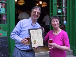 John Cryne (left) presents the Award to licensee Mary Wooderson. 