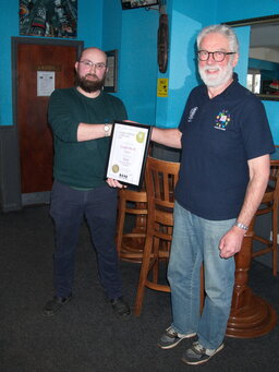 Alex Douglas (Logan Beck Brewery) receives the certificate for CAMRA's Champion Beer of Britain (Session Bitter) for their  Proper from Stephen Walker