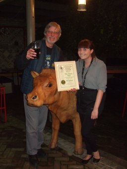 Genevieve Gardiner (right) accepts the Award from John Cryne while the cow looks on!