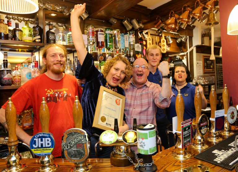 The Seven Stars staff celebrating receiving the Rugby & District Pub Of The Year certificate