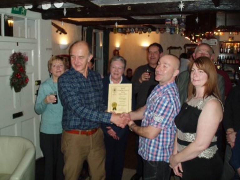 Fenland's Chairman Nigel Woodburn presenting the certificate to Jon and Su, and fellow Fenland members and Councillors.