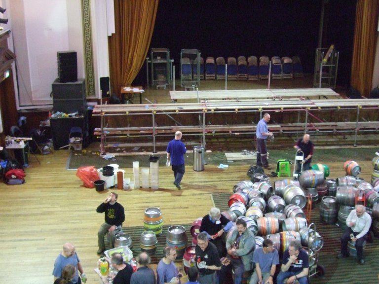The crew take a breather surrounded by empty barrels and cleared scaffolding. 