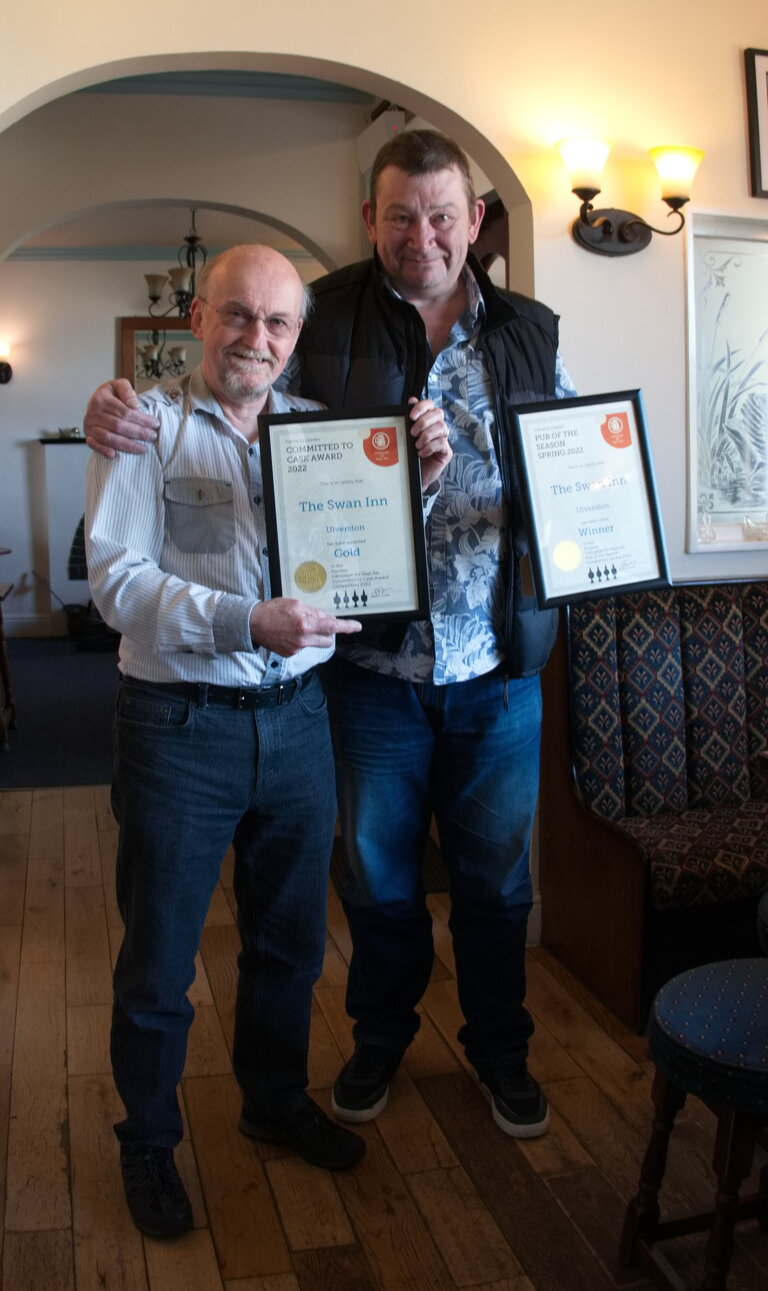 Gary, Landlord of The Swan Inn, receiving two awards from Furness Branch Chair. First, Pub of the Season, Spring 2022 and Second, Committed to Cask award for his continuing support of Cask Ale and maintaining the quality of his beers.