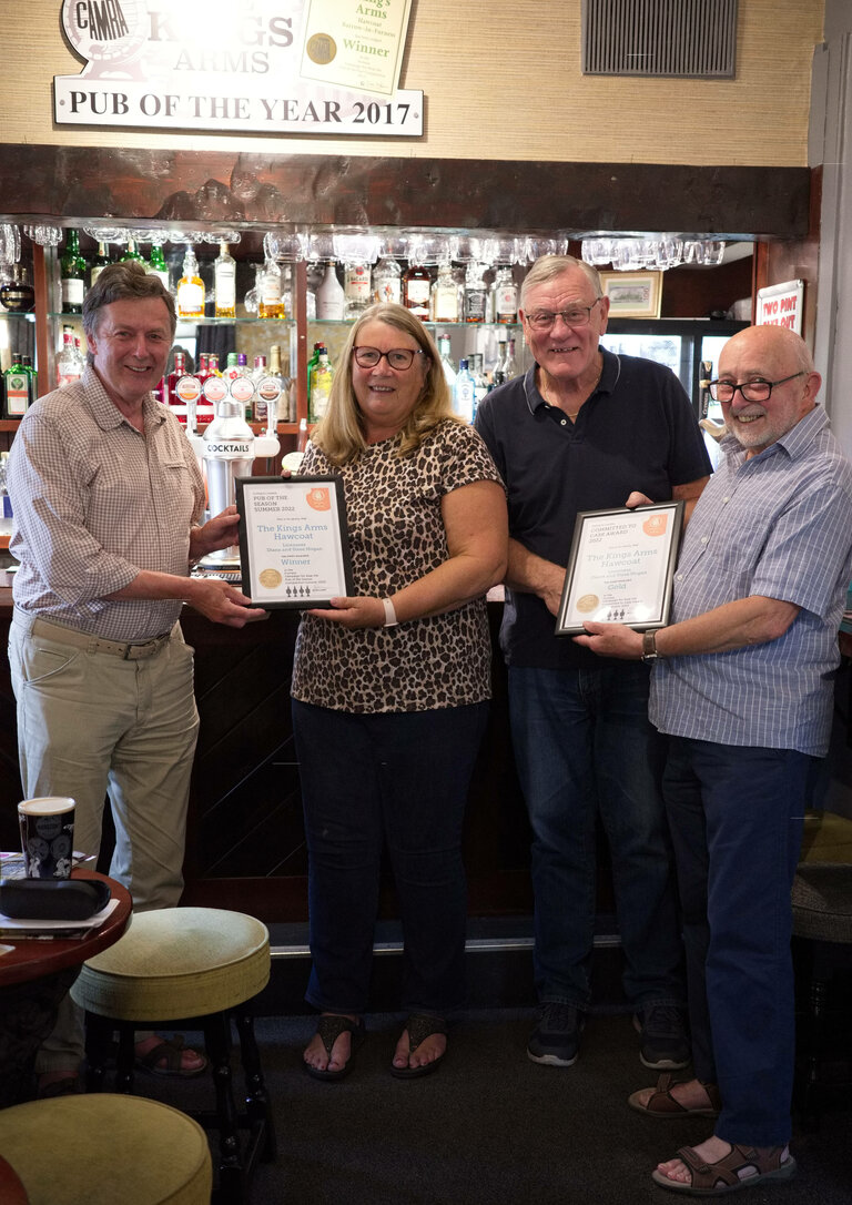 Ken Parr and Colin Scraggs presenting two awards for Summer Pub of the Season and Commited to Cask to Diane and Steve Hogan of the Kings Arms in Hawcoat.