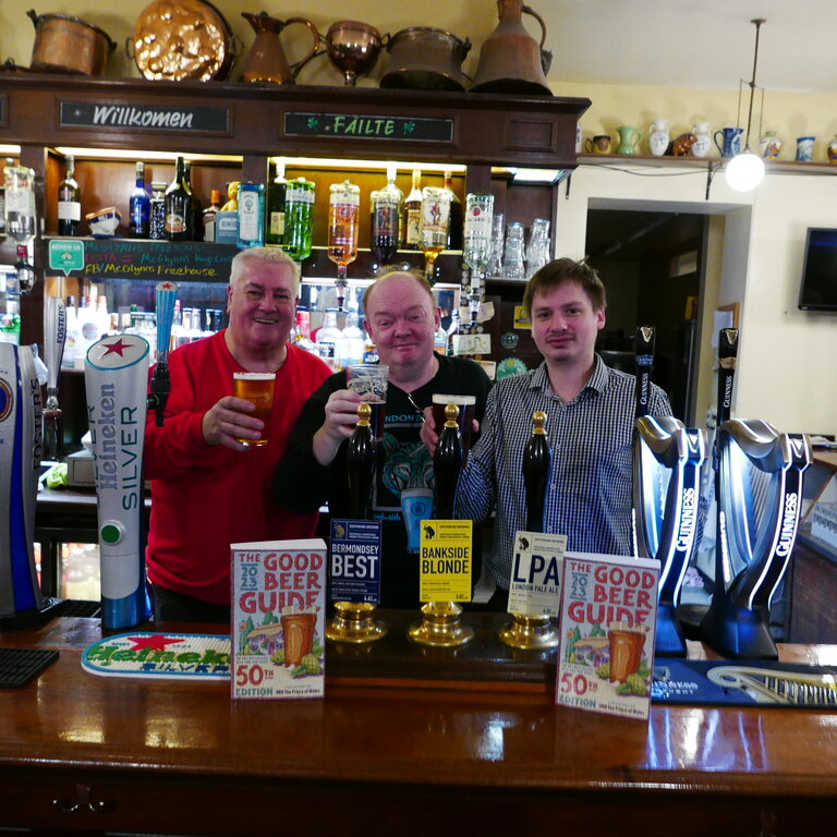 Peter Jackson of Southwark Brewery to the left and manager Liam Birney to the right celebrate with Branch Chairman Colin Coyne on the pub's inclusion in CAMRA's 50th Good Beer Guide.
