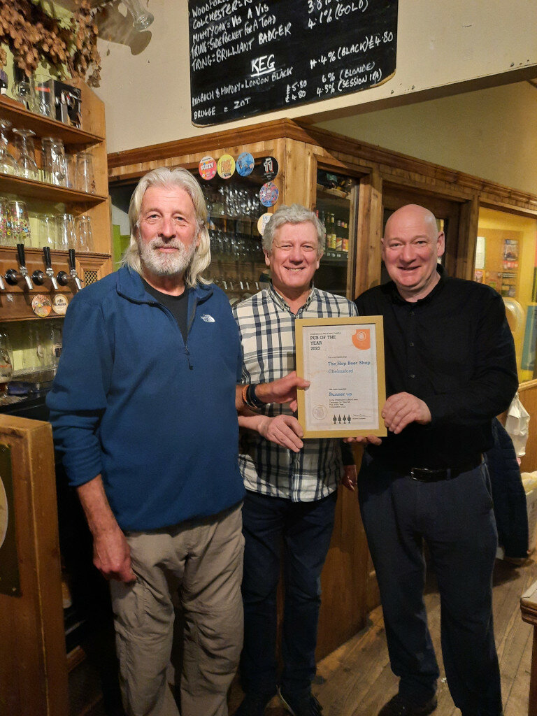 CME Chair Norman Robinson presents the branch Pub of the Year Joint Runner-up 2023 Award to John and Phil at the Hop Beer Shop, Chelmsford