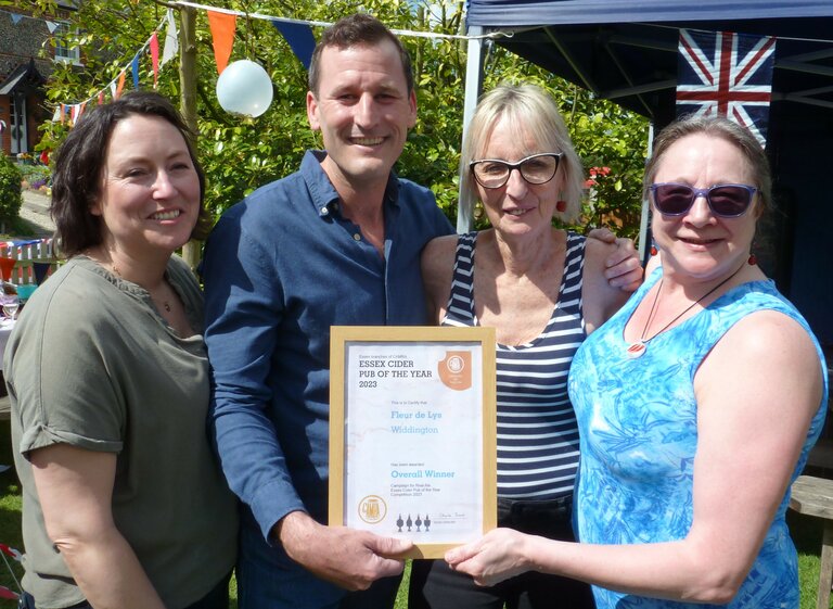 Liz Gurr, Northwest Essex Branch Cider Representative, and Claire Irons, Essex Cider Representative (second from right and far right) present the Essex Cider Pub of the Year Award 2023 to Ellie and Chris Rosetto of the Fleur de Lys, Widdington.