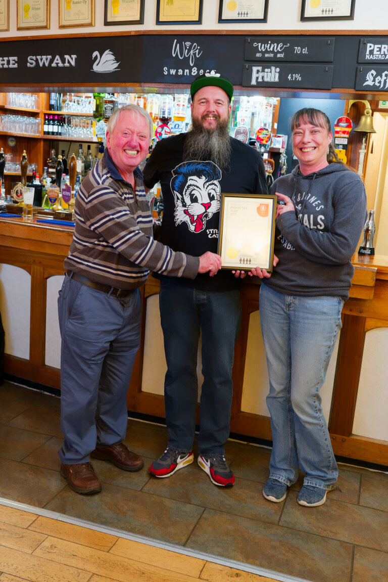 Sarah and Lewis receive their certificate for Furness CAMRA Pub of The Year 2024 from Deve Stubbins