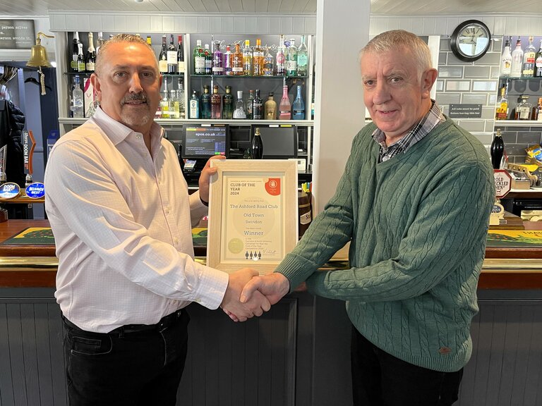 Malcolm Brownlee (left) accepts the Club of the Year certificate from Paul New.