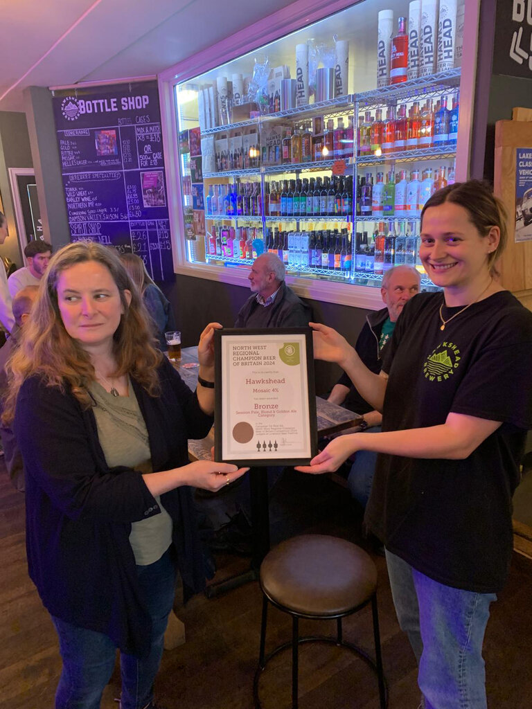 Diane Simpson from Furness Branch presents the Certificate for Northwest Region Champion Beer of Britain 2024 (Bronze) to Hawkshead Brewery for their Hawkshead Mosaic