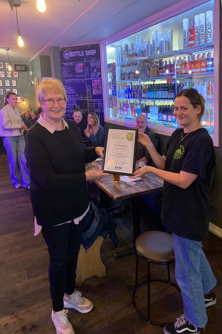 Janet Ridal of Furness Branch presents the Certificate for Northwest Region Champion Beer of Britain 2023 (Bronze) for Hawkshead Mosaic