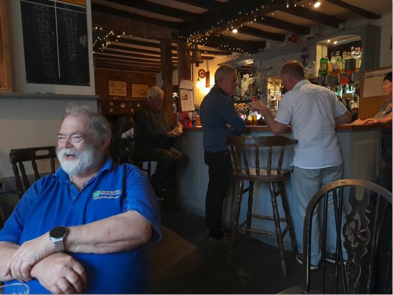 Chris enjoying a joke with the bar in the background