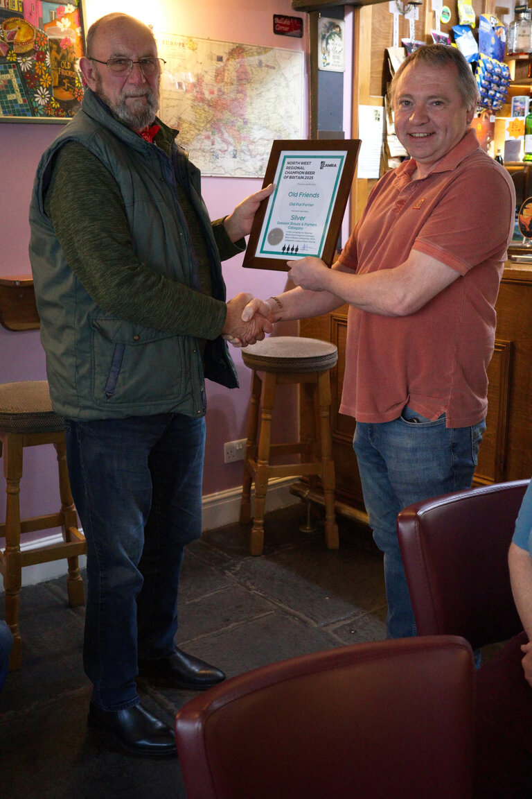 Terry Ridal presents Graham at The Old Friends, Ulverston with the Certificate for Silver in the NW Region Champion Beer of Britain awards 2025 for Old Friends Porter which is brewed on the premises. Lovely it is too.
