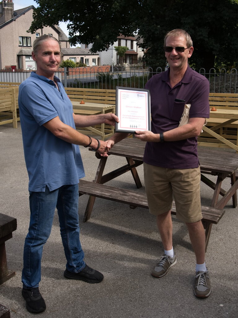Simon Walker (Bar Manager) presented with the award for Excellent Management at the Devonshire in Ulverston. Presenting the award is Furness Member Neil Braithwaite 