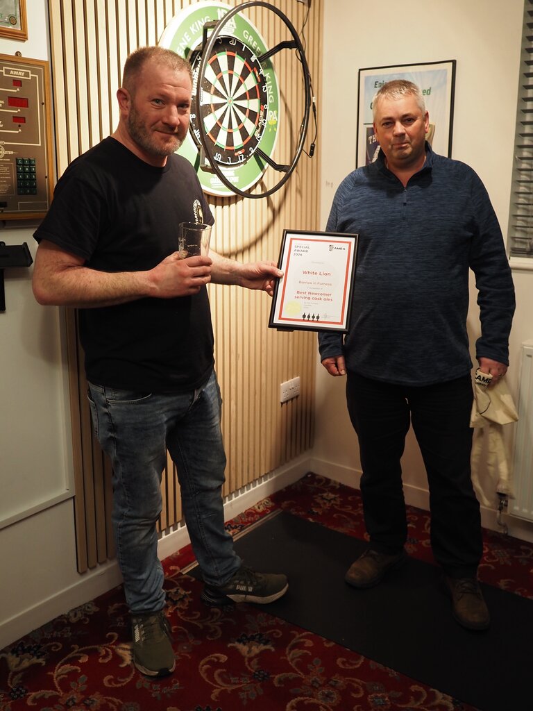 Adam Taylor of the White Lion, Barrow in Furness receives the Best Newcomer serving Cask Ale award from Furness Member Andy Donnan during the Logan Beck Cask Takeover Event on 10th February 2026