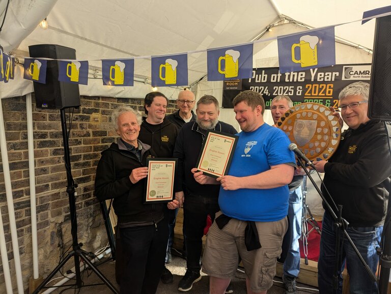 James Thornton presenting the shield and certificates to members of the Engine Room team