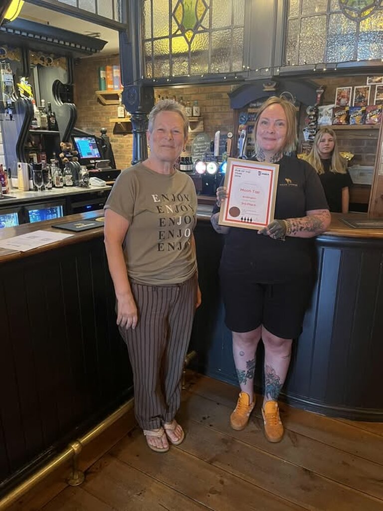 22nd May 2026. Jonquil Beynon presents Julie at The Moon Tap with their 3rd place award for Pub of the Year 2026. 22nd May 2026. Jonquil Beynon presents Julie at The Moon Tap with their 3rd place award for Pub of the Year 2026.