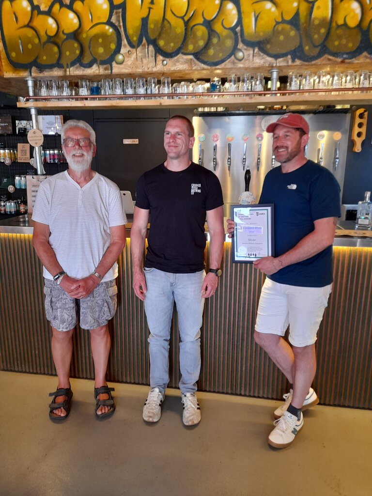 Stephen Walker (Cumbria Area Organiser - on the left) with Crooked River presenting the certificate for their Bitter that picked up Silver in the 2026 Champion Beer of Britain awards. 