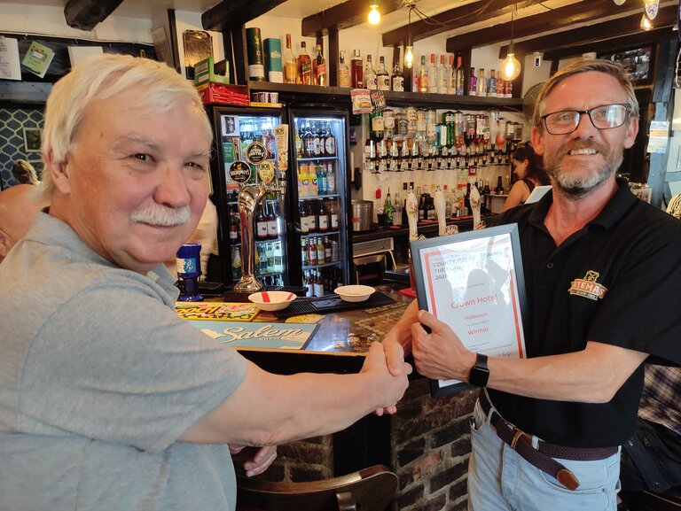 Bob Foulgar (left) presents the certificate to Stuart Griffiths