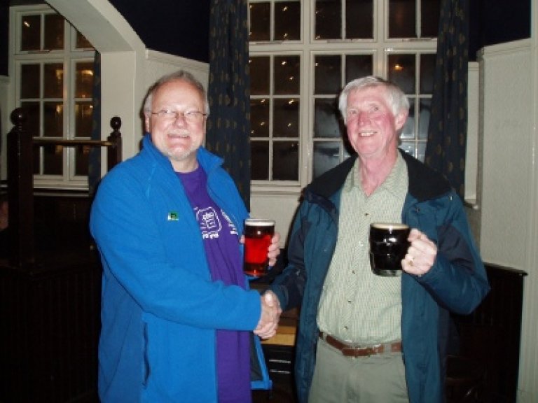 Dave (on the right) receives his prize from Ray