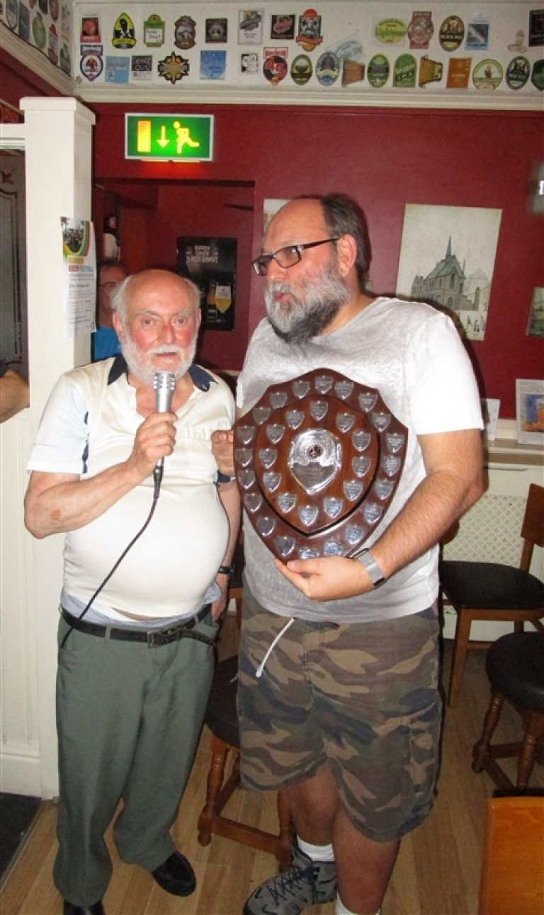 Peter Cash presents shield to Malcolm Cornelius