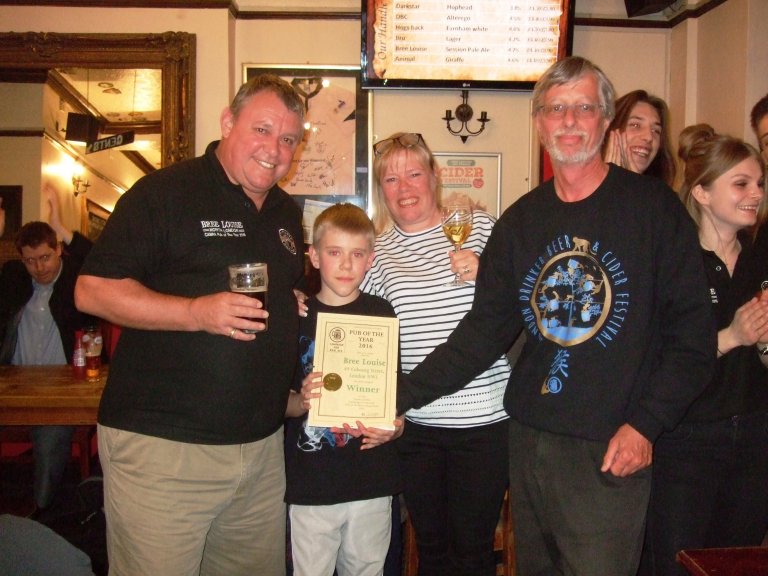 Craig and Karen Douglas with son George receive their Award from John Cryne